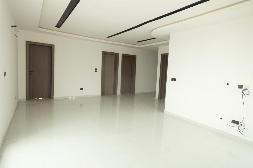 Brum Height 5: Unfurnished living space with a recessed ceiling and adjoining rooms